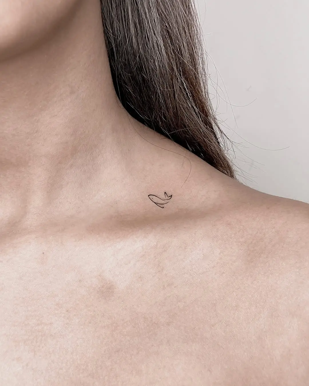 Delicate Whale Tattoo on Neck