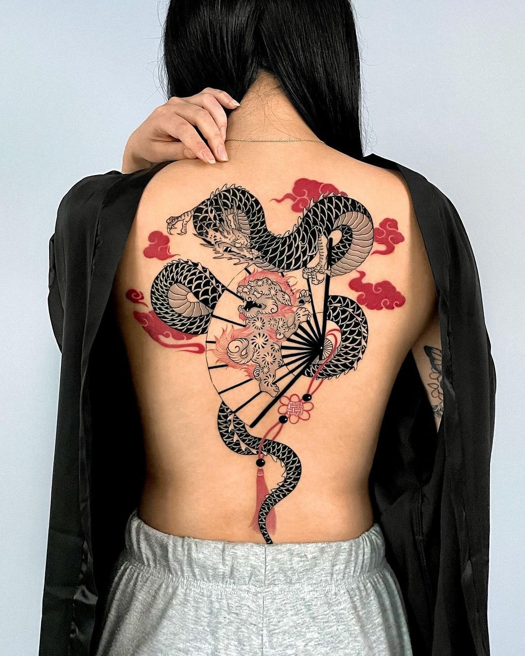 Stunning snake tattoo with floral elements