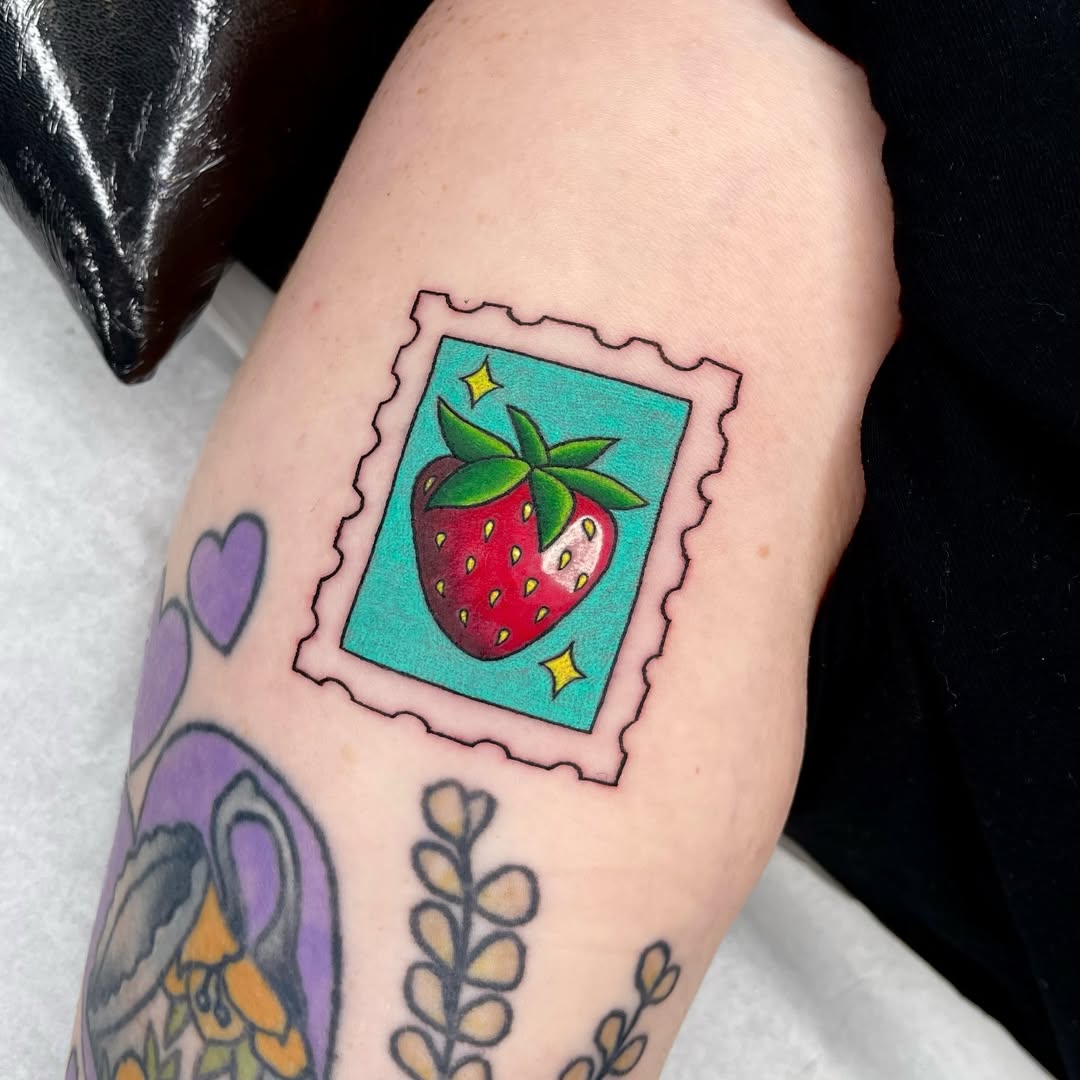 Charming strawberry stamp tattoo design