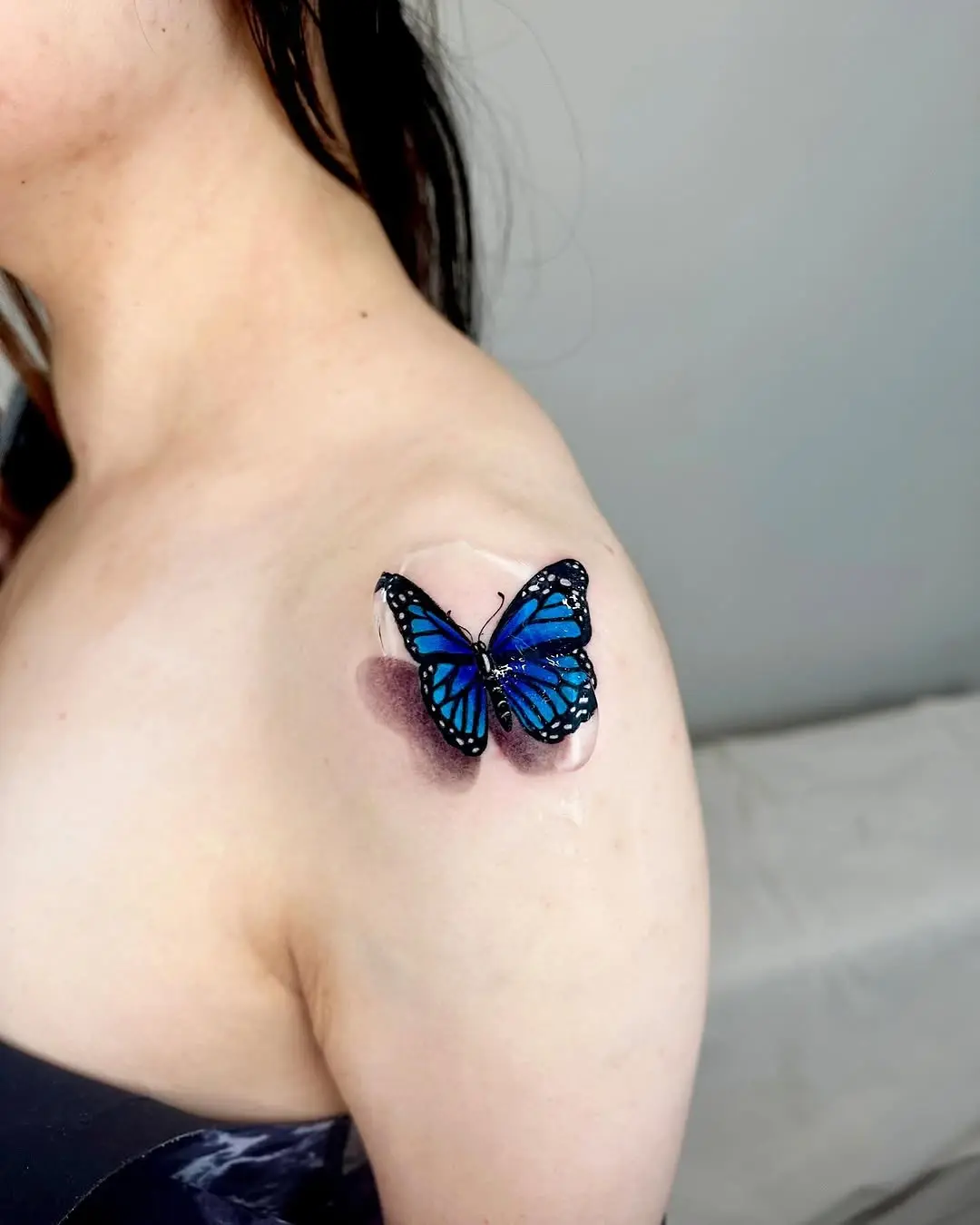 Elegant butterfly tattoo on shoulder area