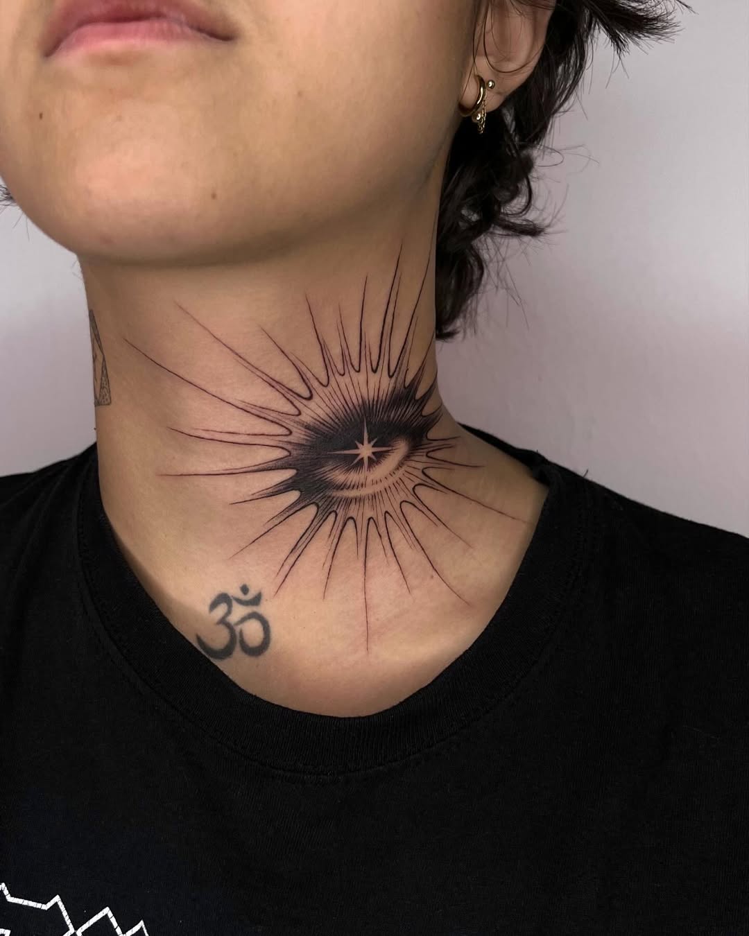 Striking eye and sunburst tattoo design.