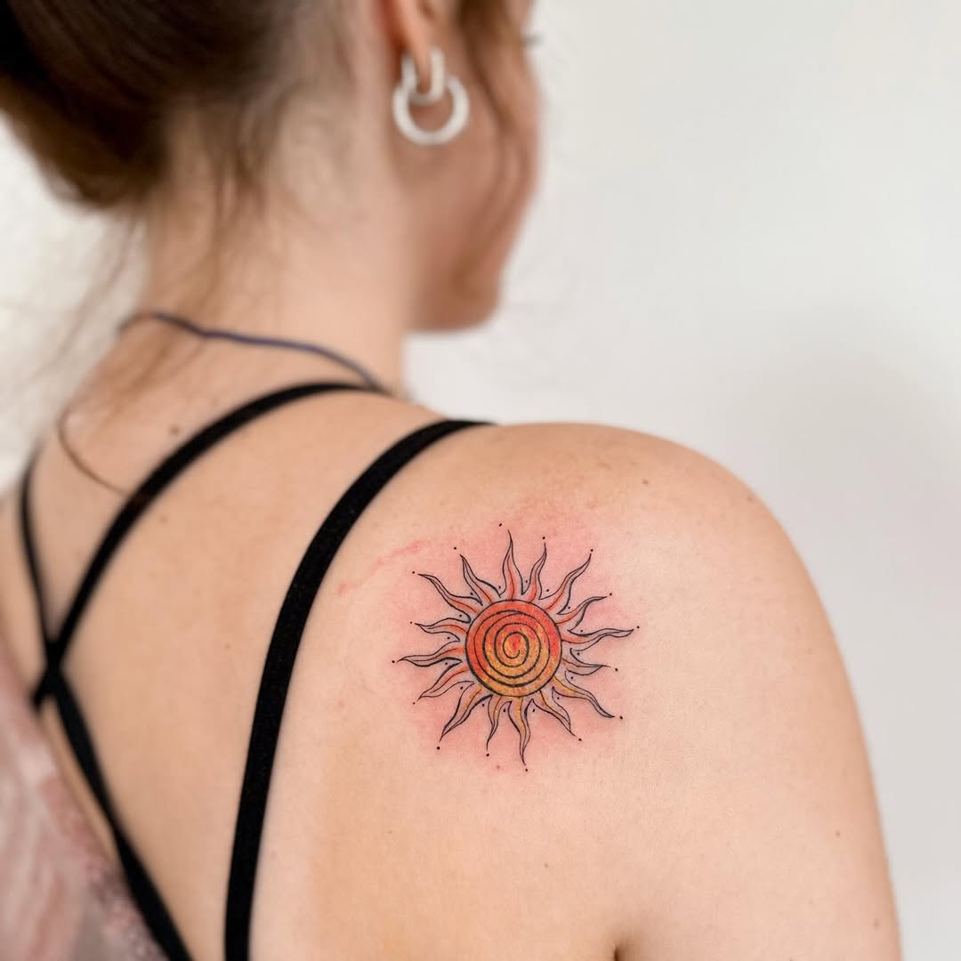 Vibrant sun tattoo with spiral design