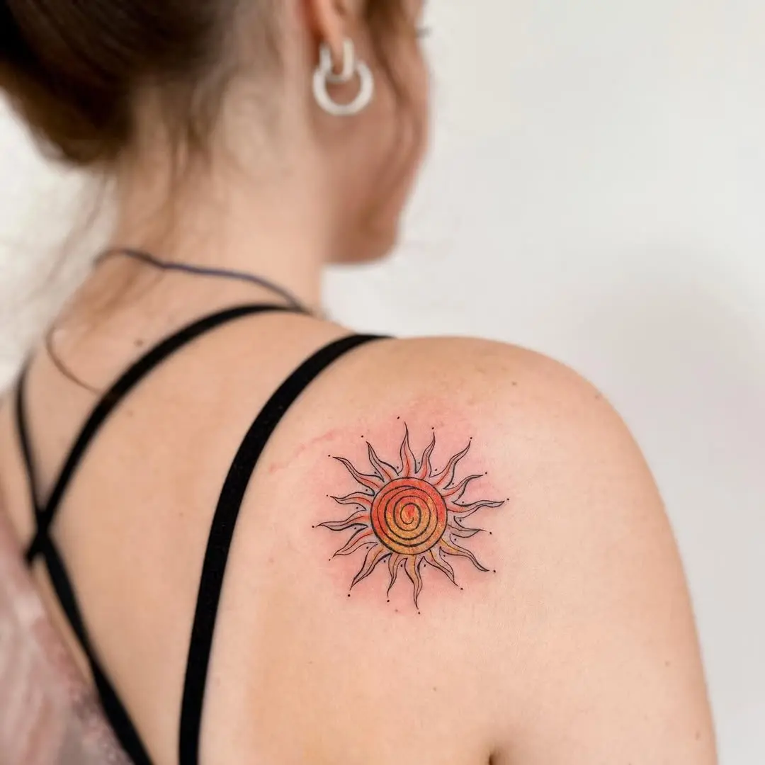 Vibrant sun tattoo with spiral design