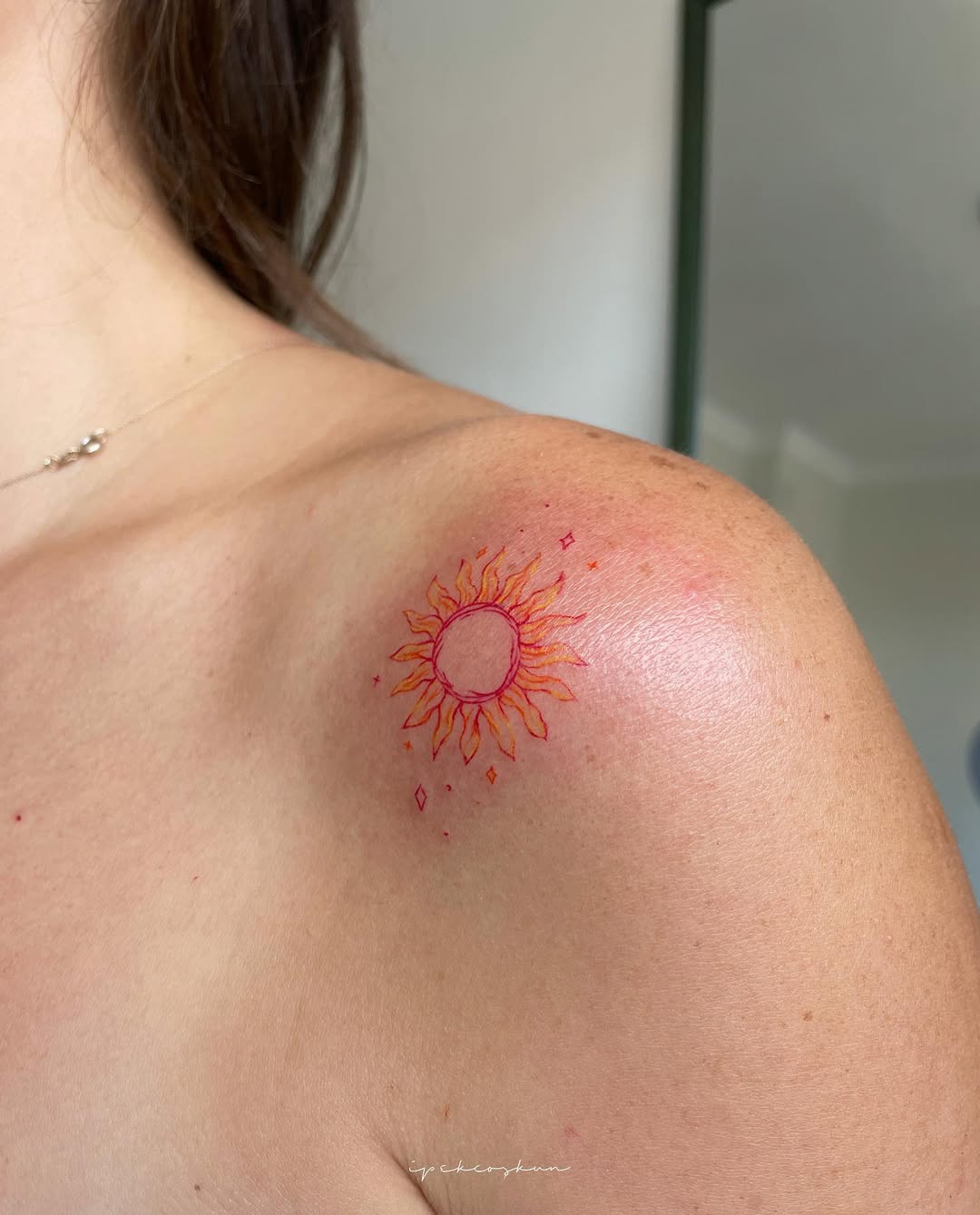 Vibrant sun tattoo with radiant energy