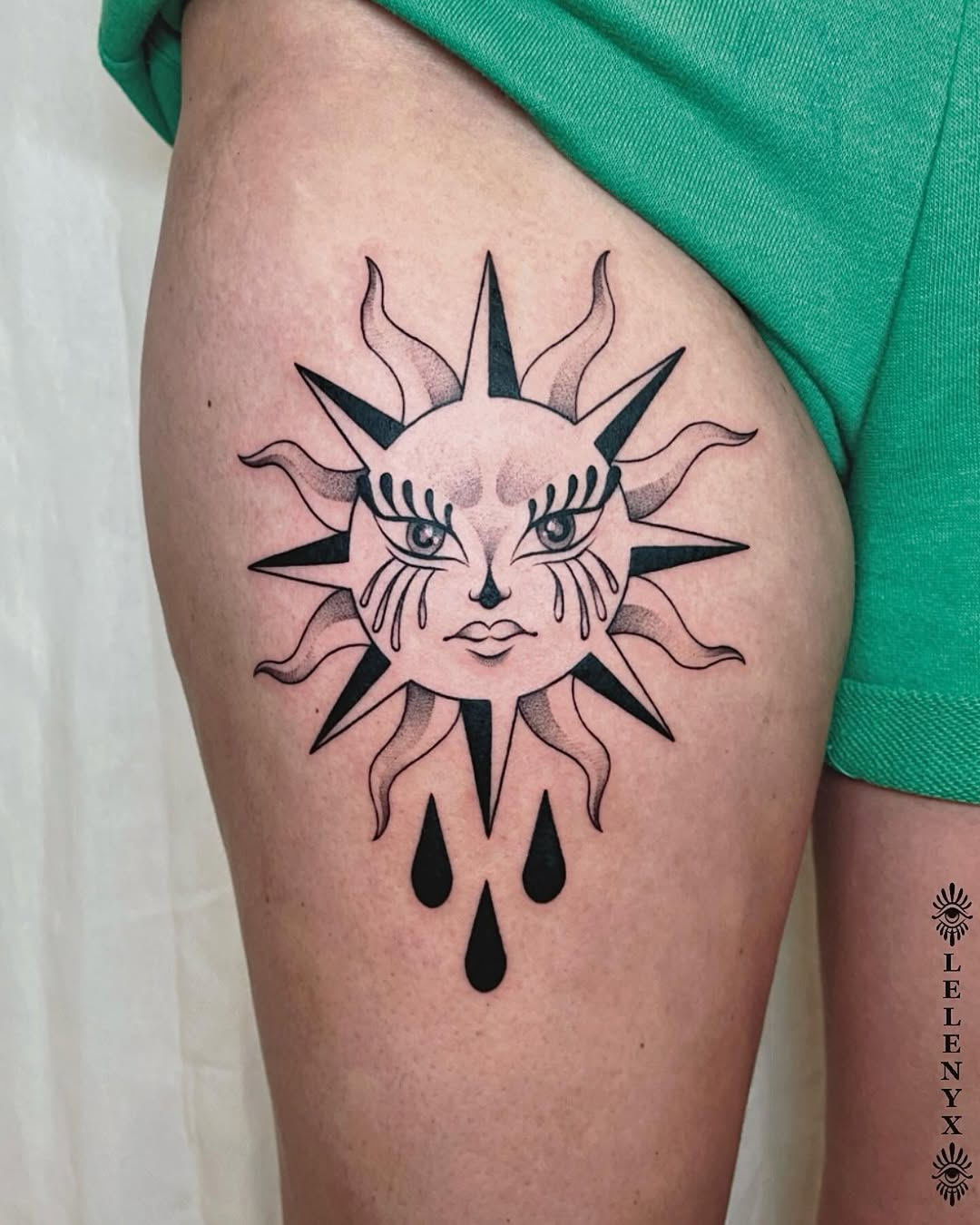 Radiant sun tattoo with expressive features