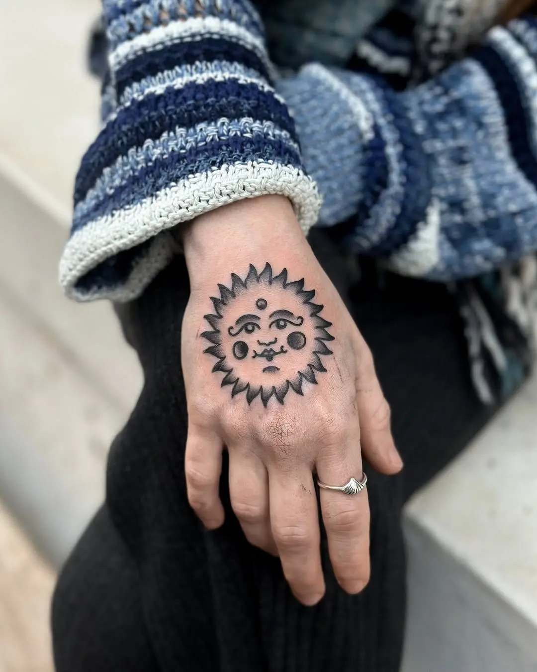 Whimsical sun tattoo with expressive features