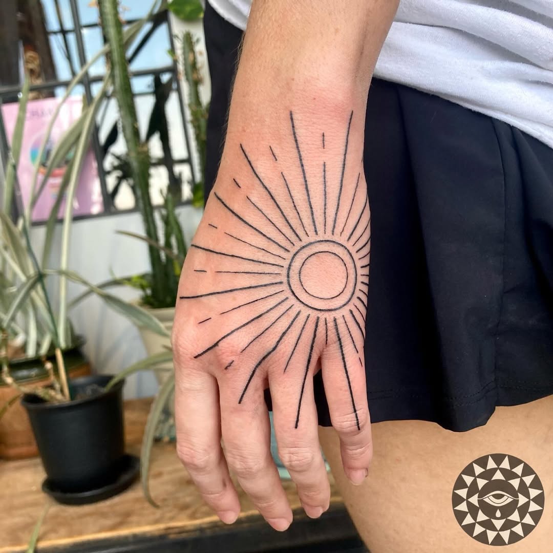 Striking Minimalist Sun Tattoo on Hand