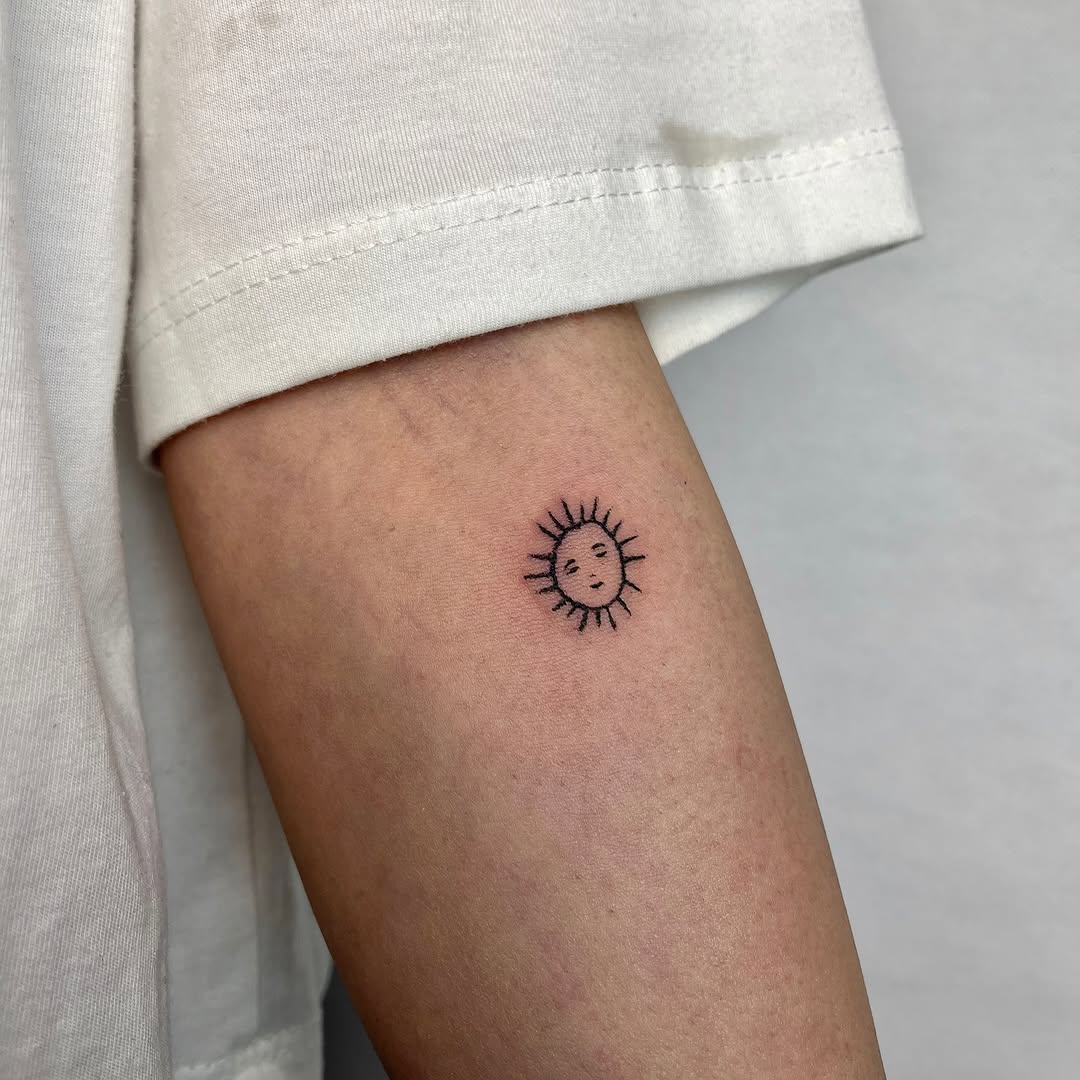 Charming minimalist sun tattoo design