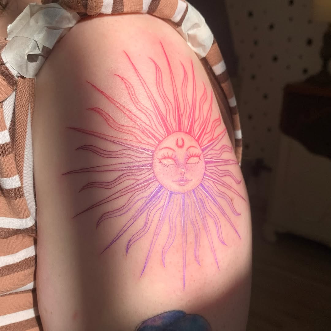 Radiant sun tattoo with vibrant, warm hues