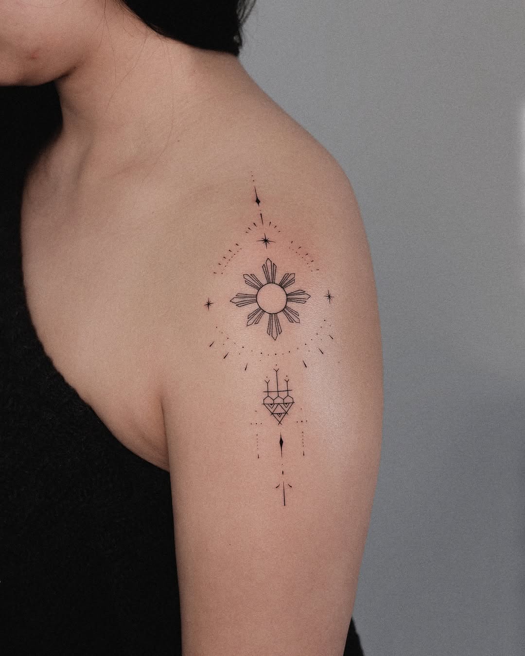 Minimalist sun tattoo with cosmic elements