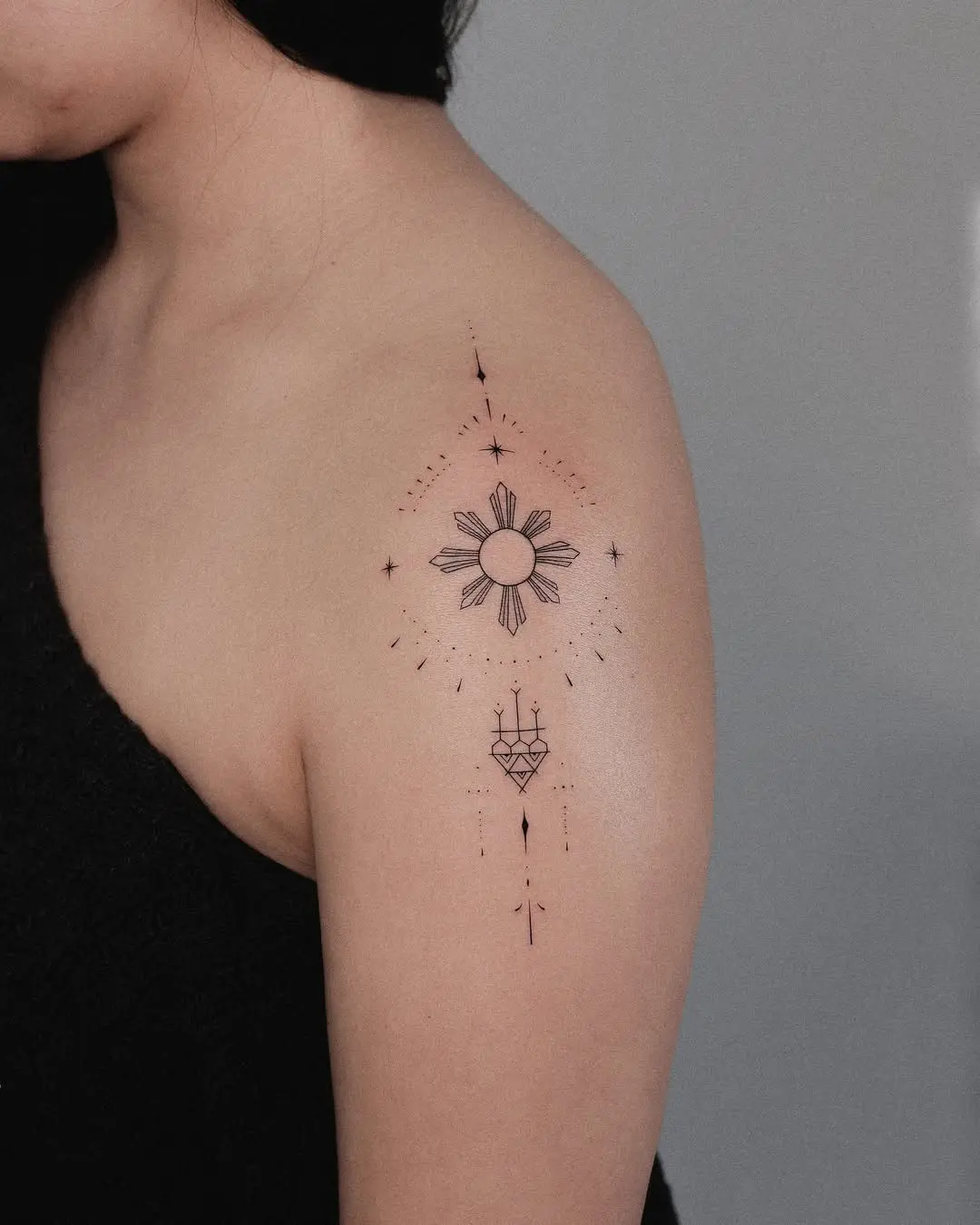 Minimalist sun tattoo with cosmic elements