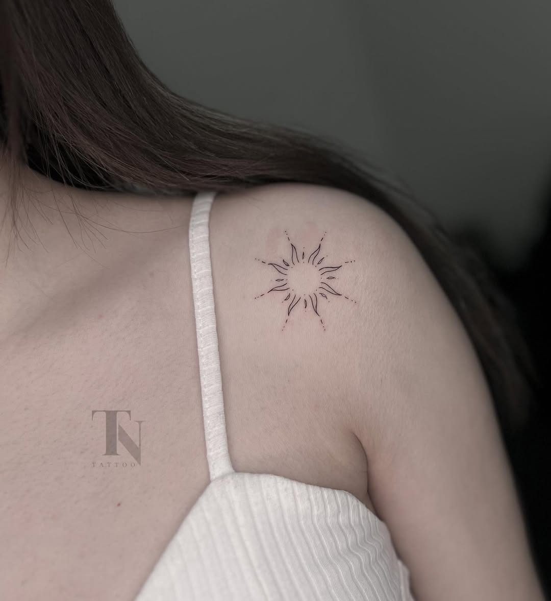 Elegant sun tattoo design on beautiful skin