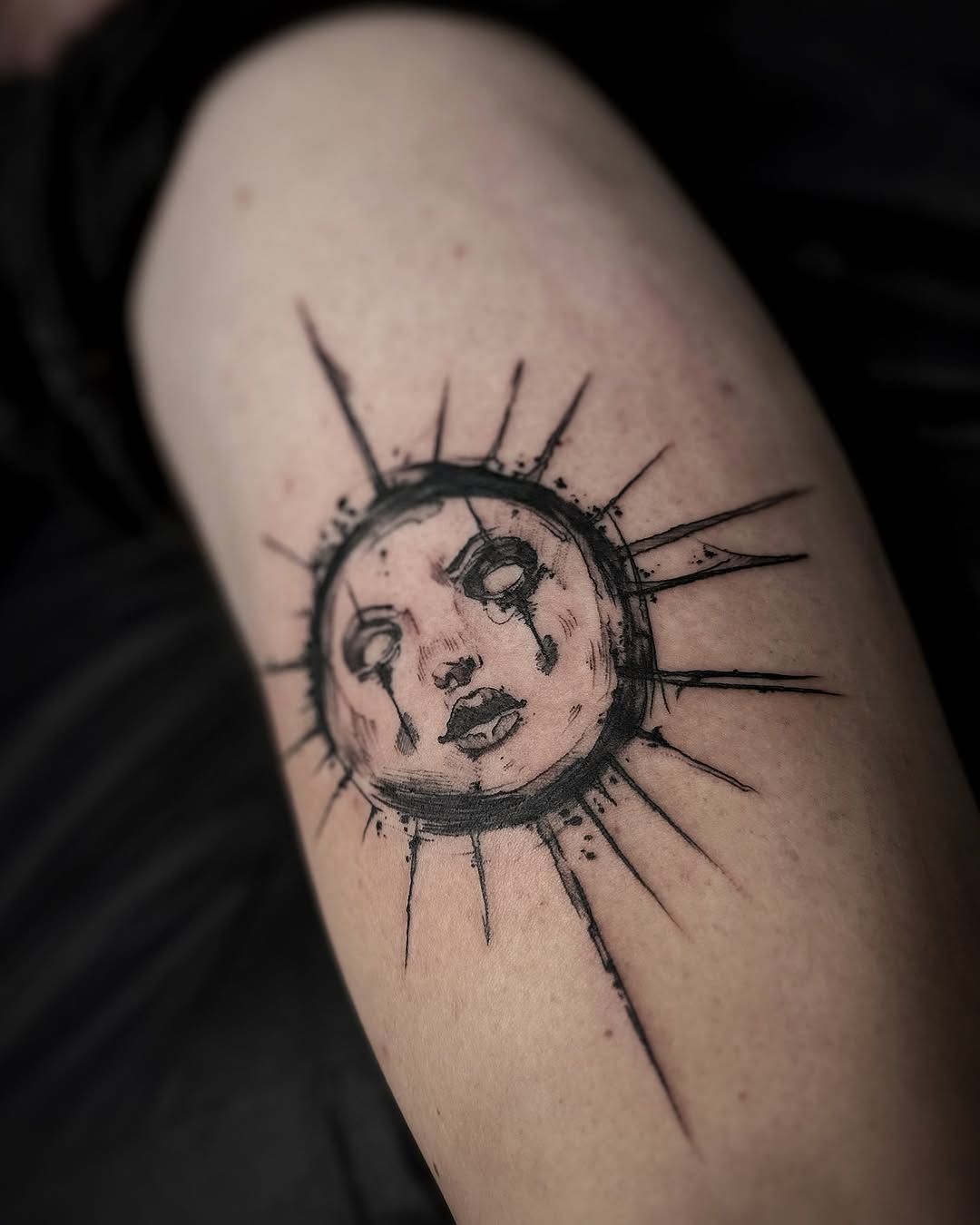 Striking sun tattoo with a unique face design