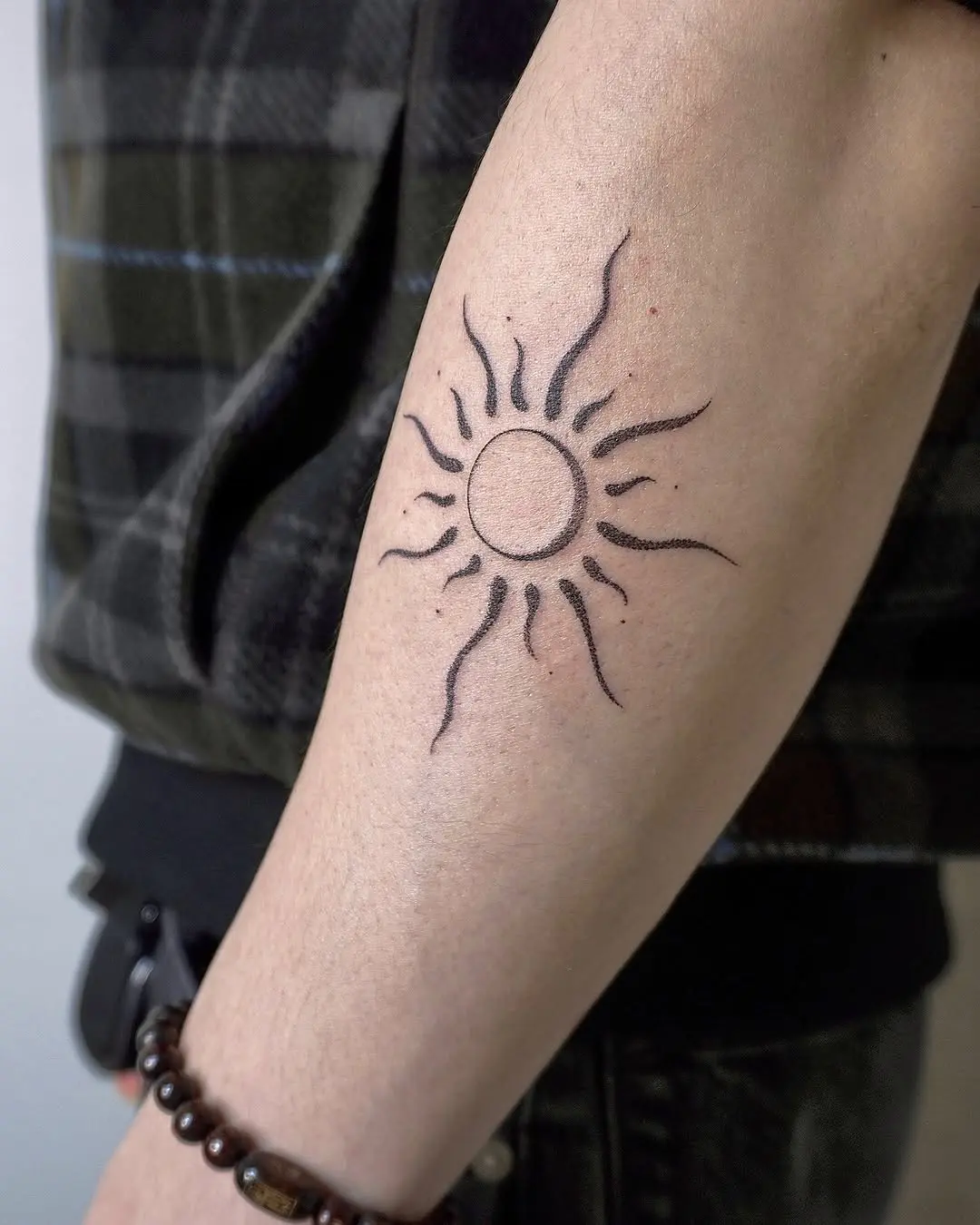 Radiant sun tattoo for yoga enthusiasts