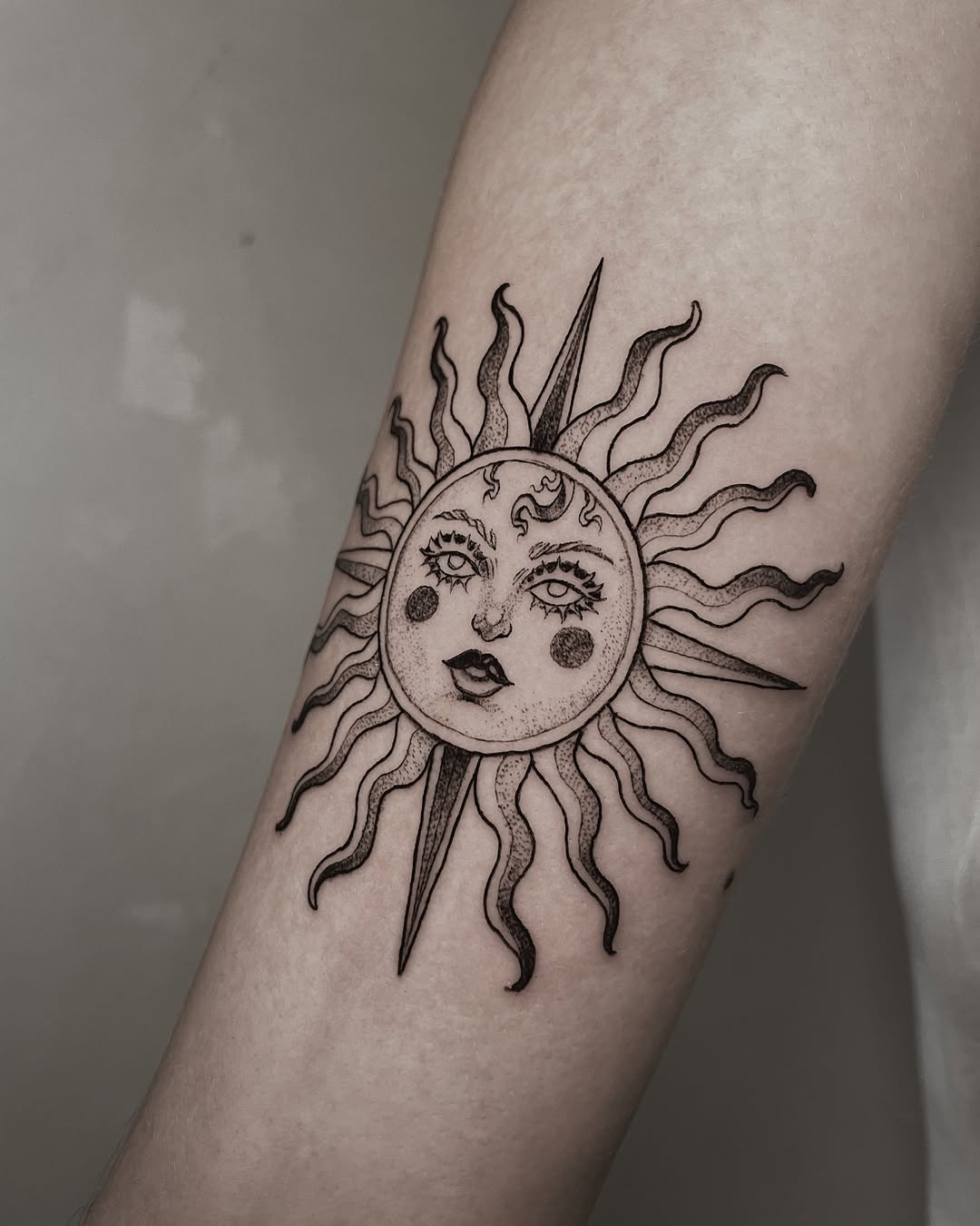 Stylish sun tattoo with captivating facial features