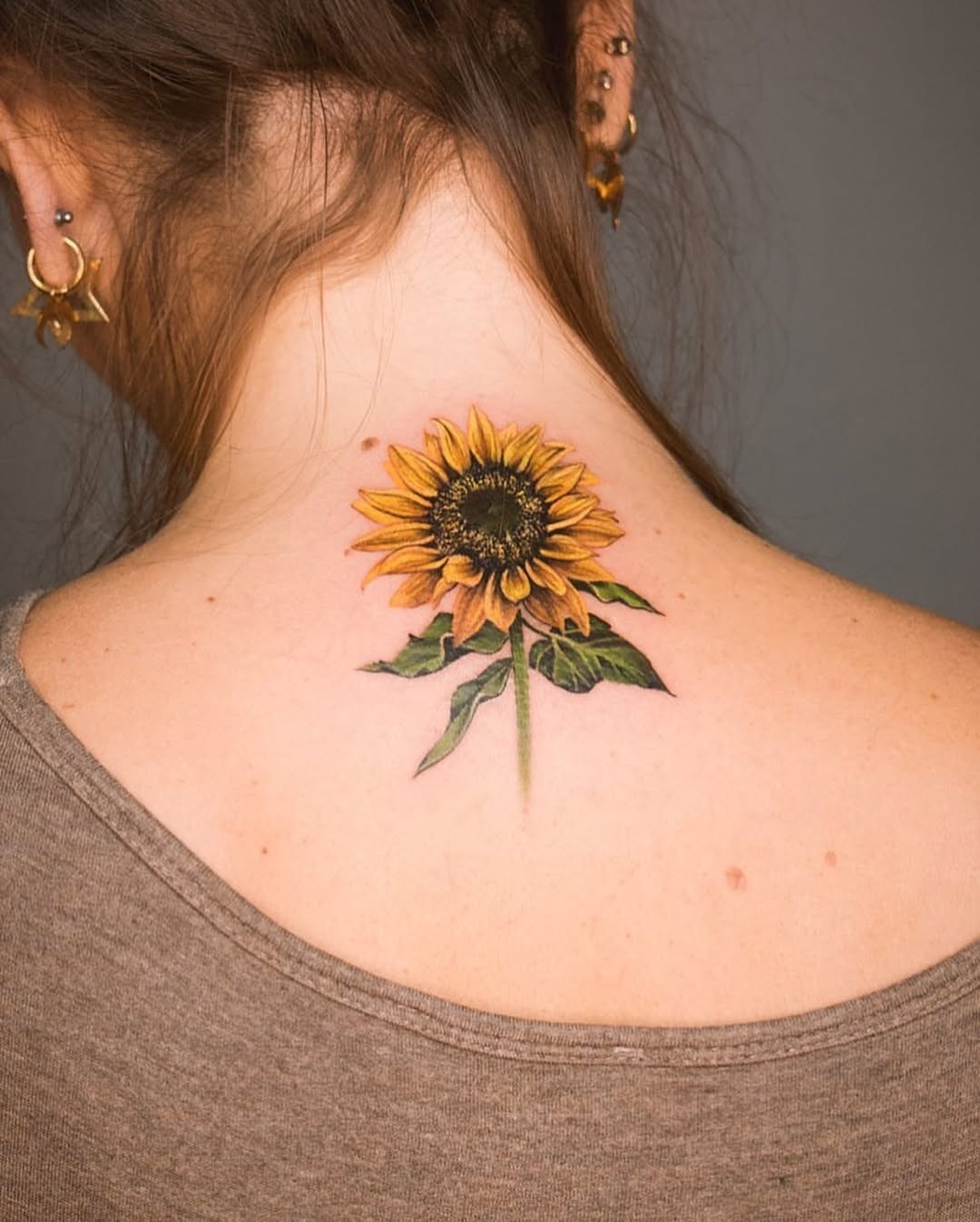Elegant sunflower tattoo on the back