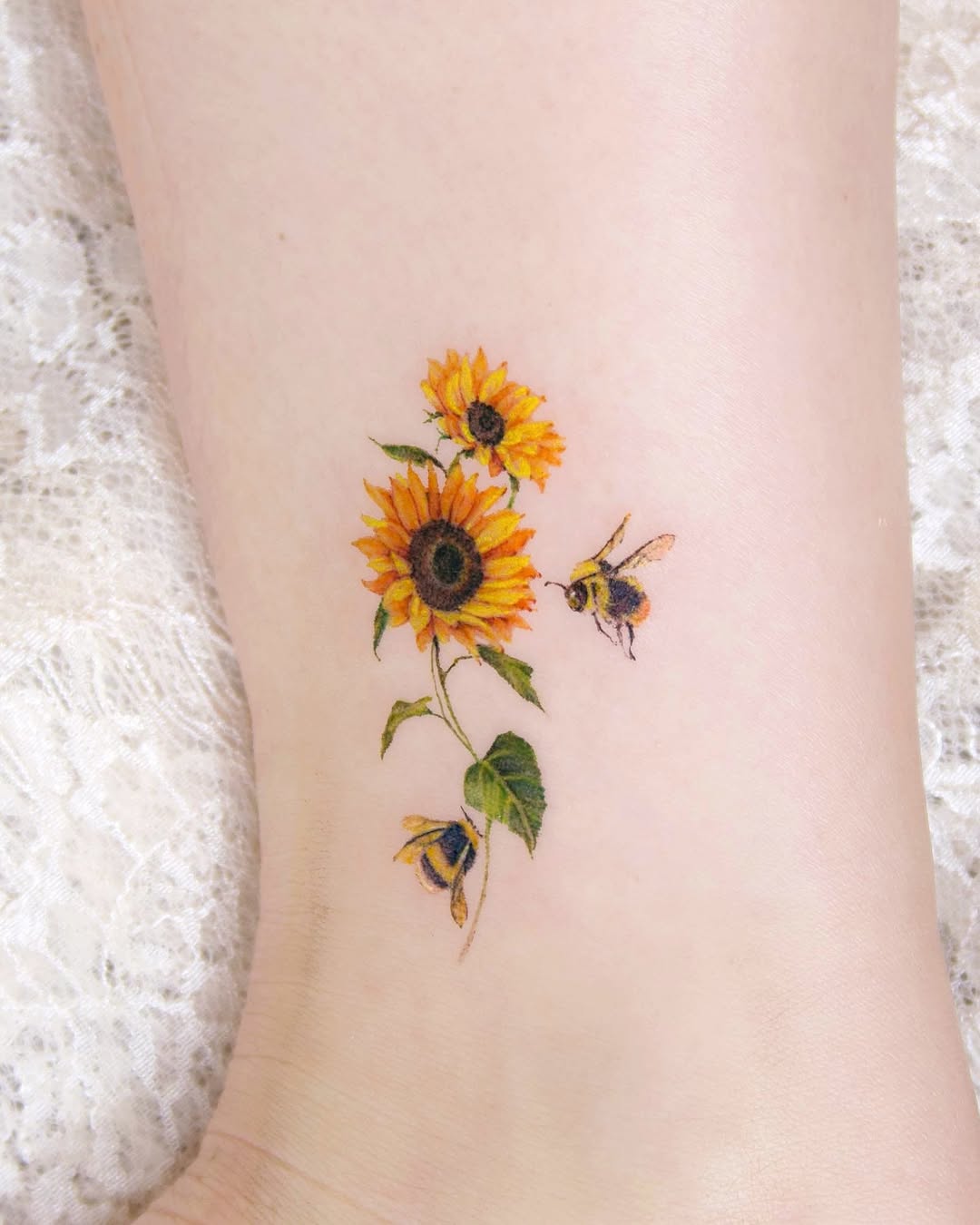 Charming sunflowers with buzzing bees tattoo design