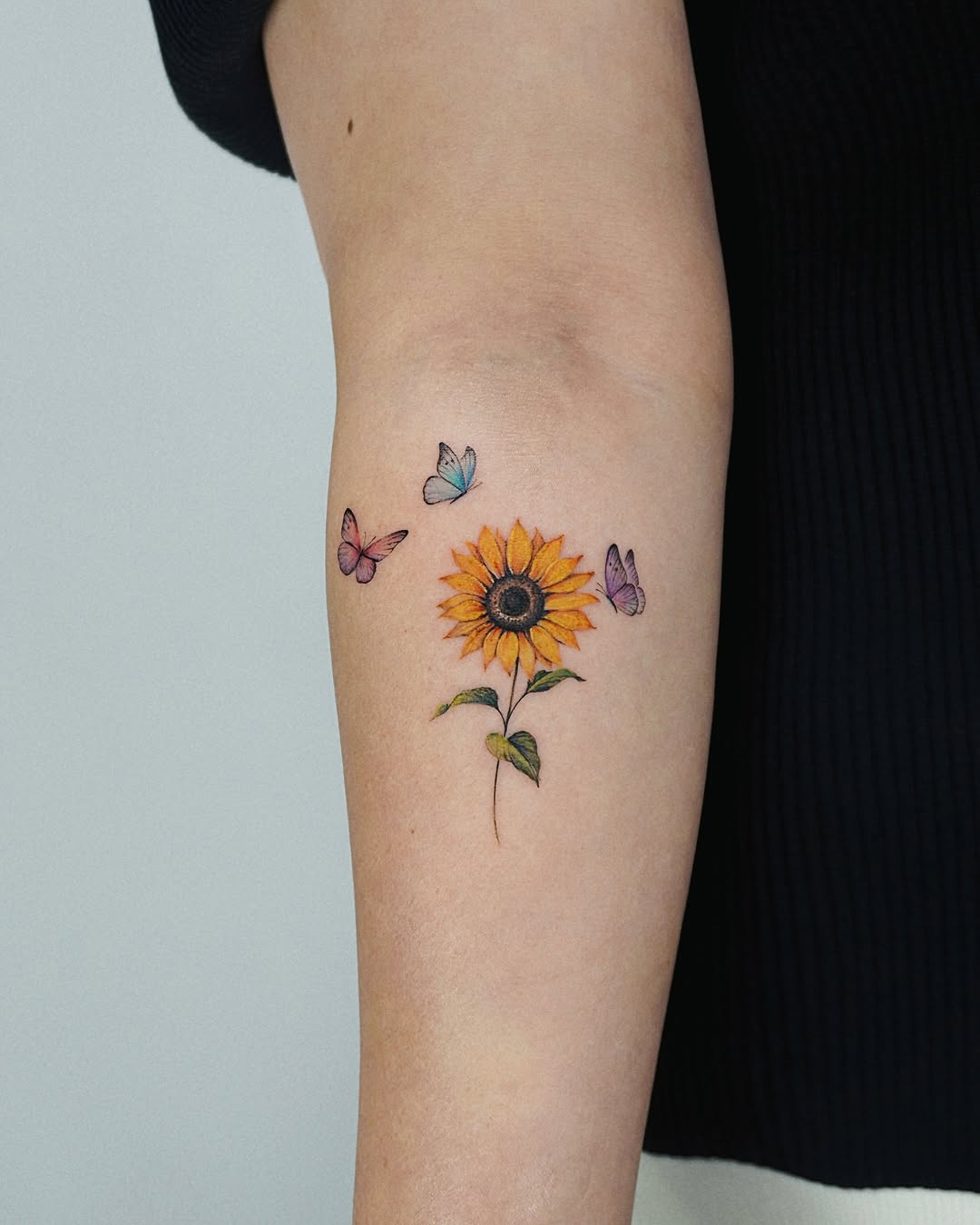 Whimsical sunflower and butterfly tattoo design