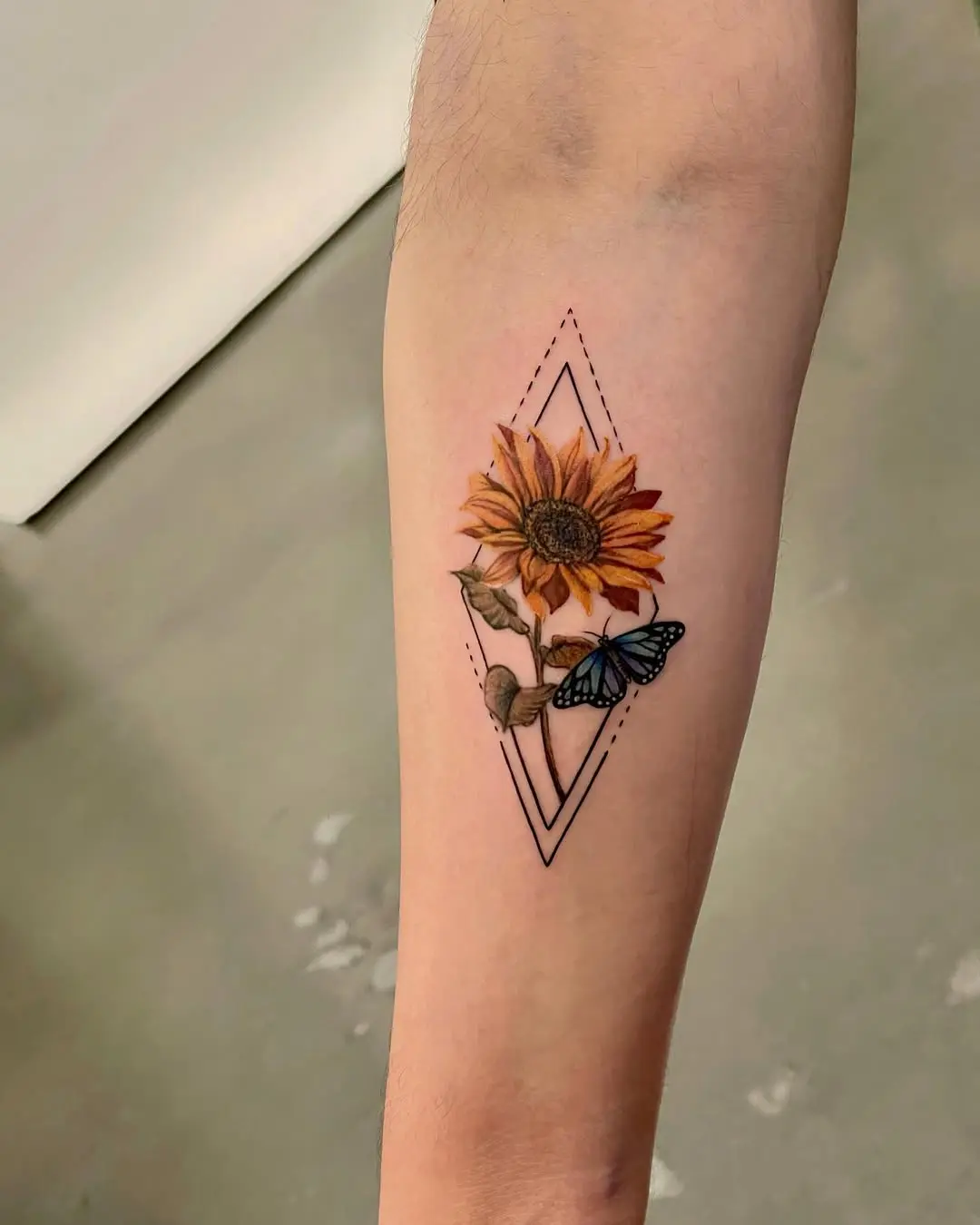 A vibrant sunflower embraced by a butterfly.