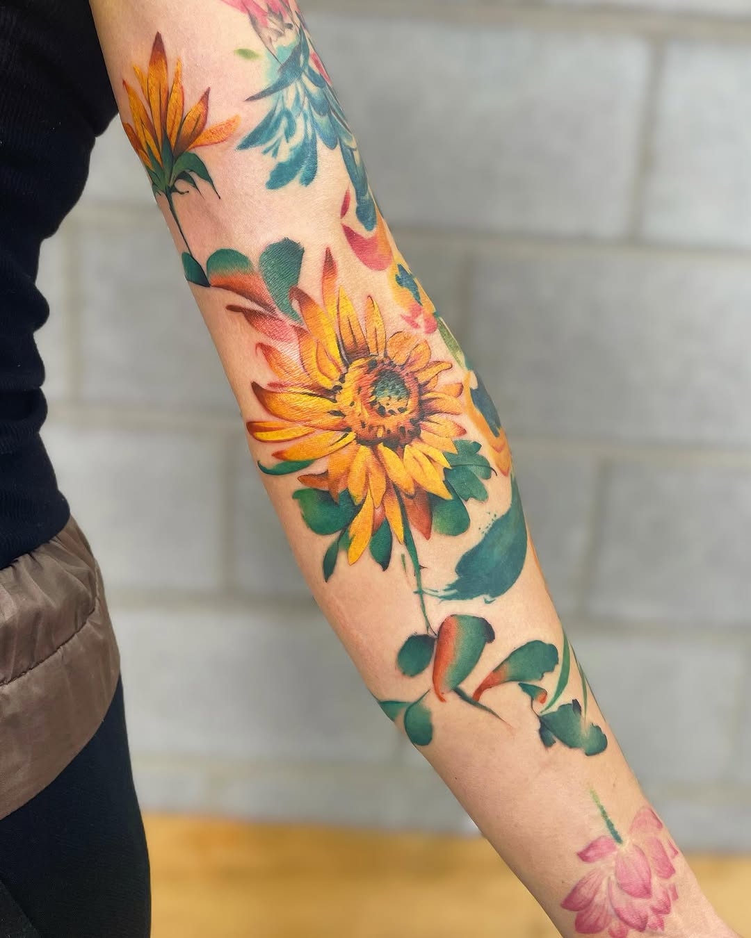 Vibrant sunflower tattoo with lush greenery