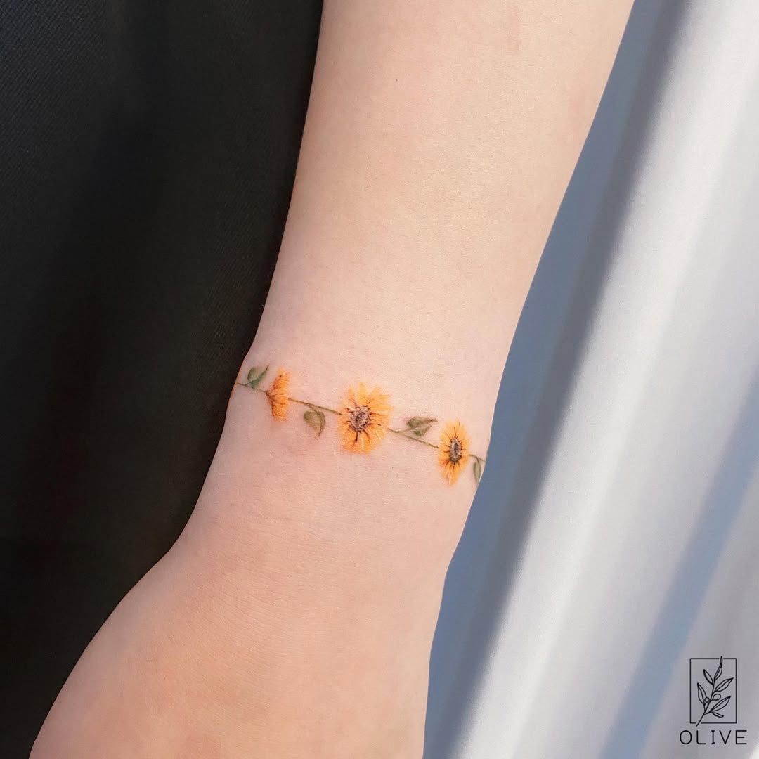 Beautiful sunflower tattoo on delicate wrist