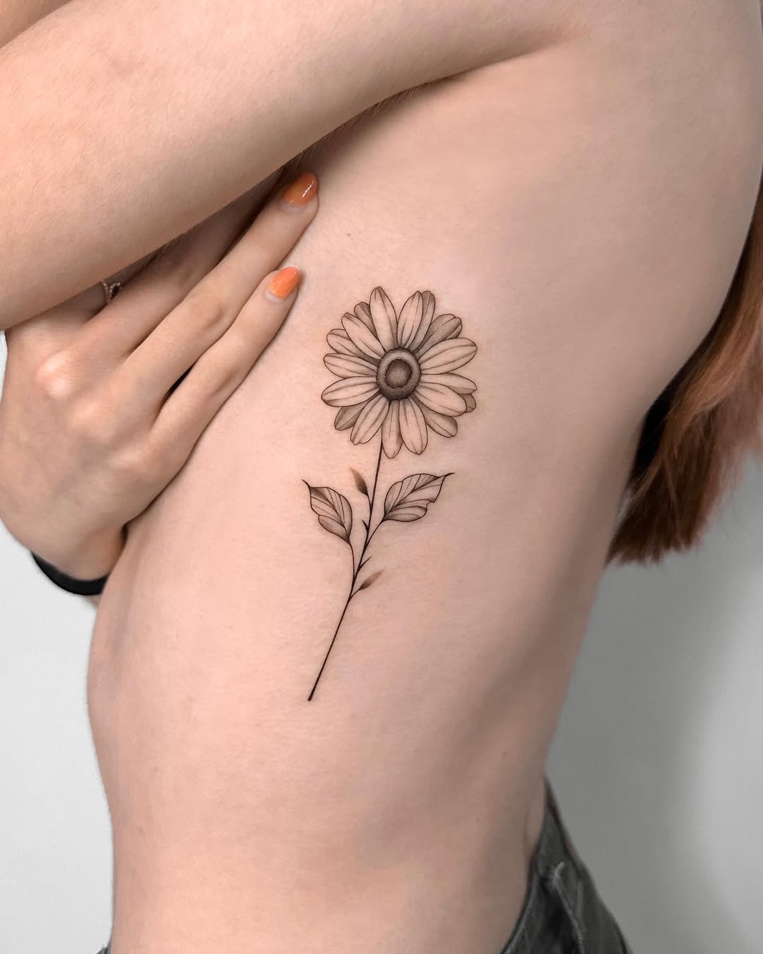 Elegant sunflower tattoo on side body