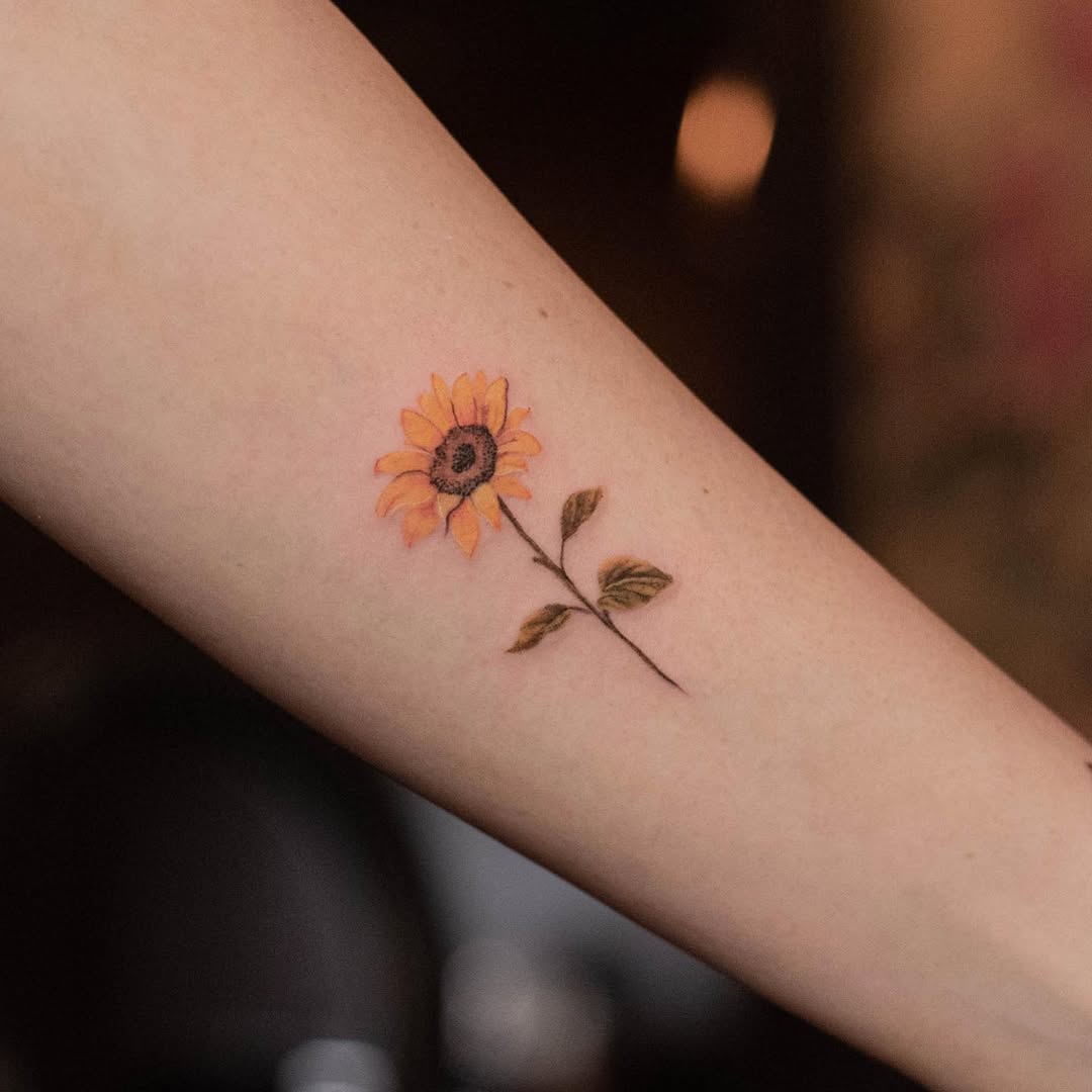 Delicate sunflower tattoo on the arm