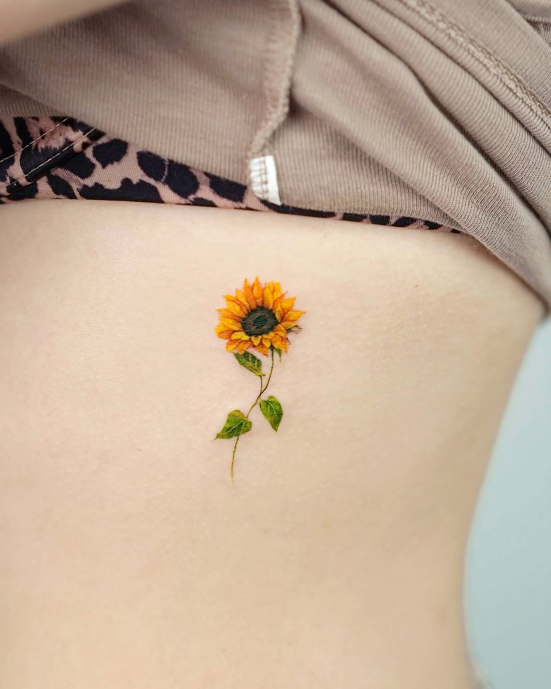 Elegant sunflower tattoo on the rib side