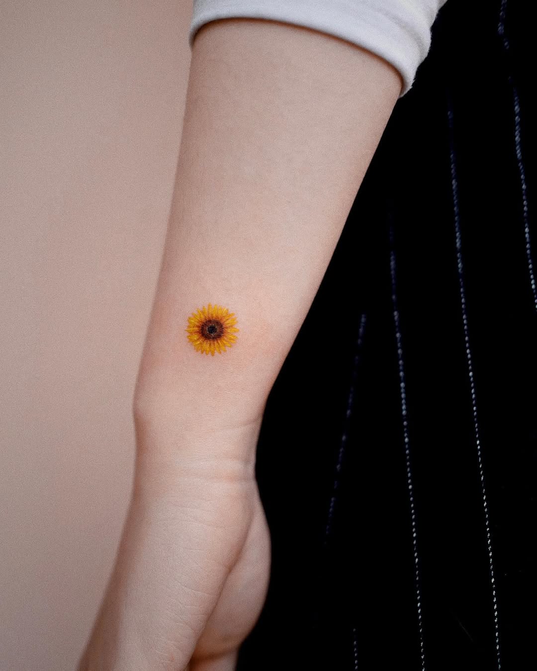 Chic sunflower tattoo on the inner forearm