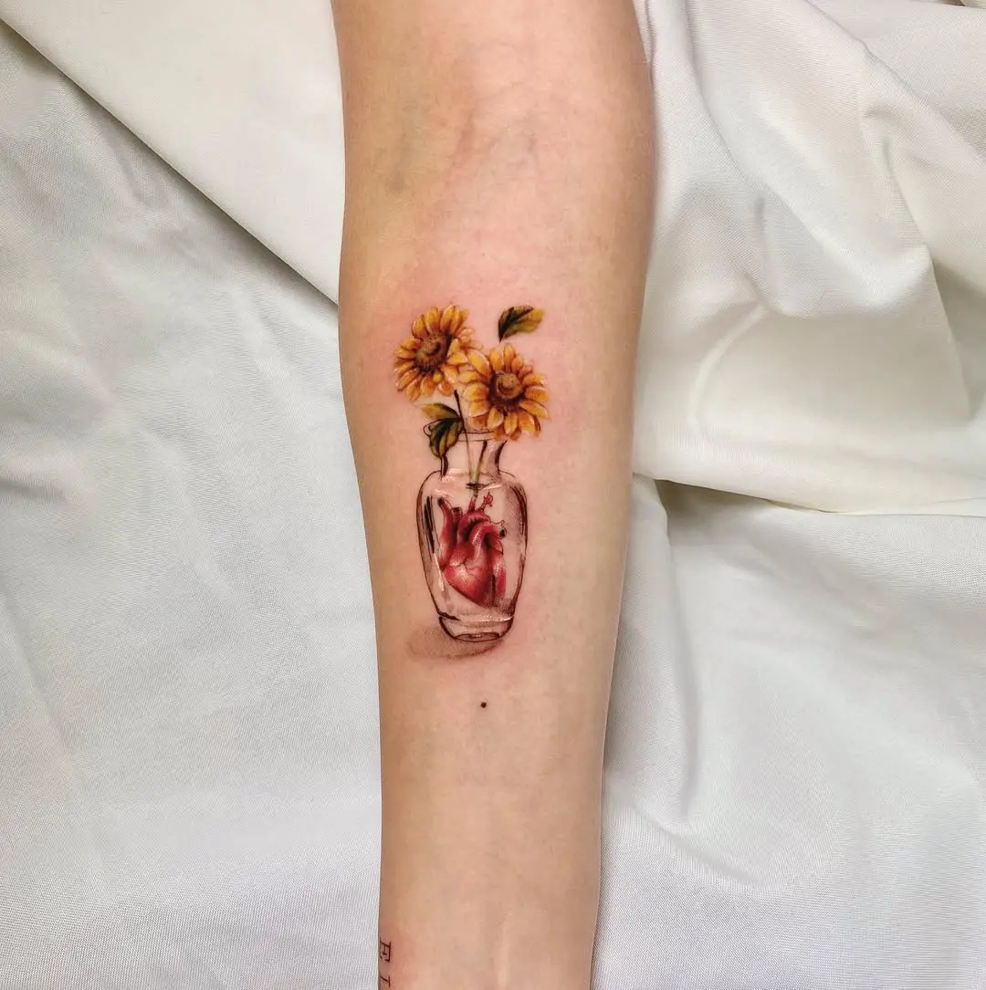 Stunning sunflower tattoo in a glass vase
