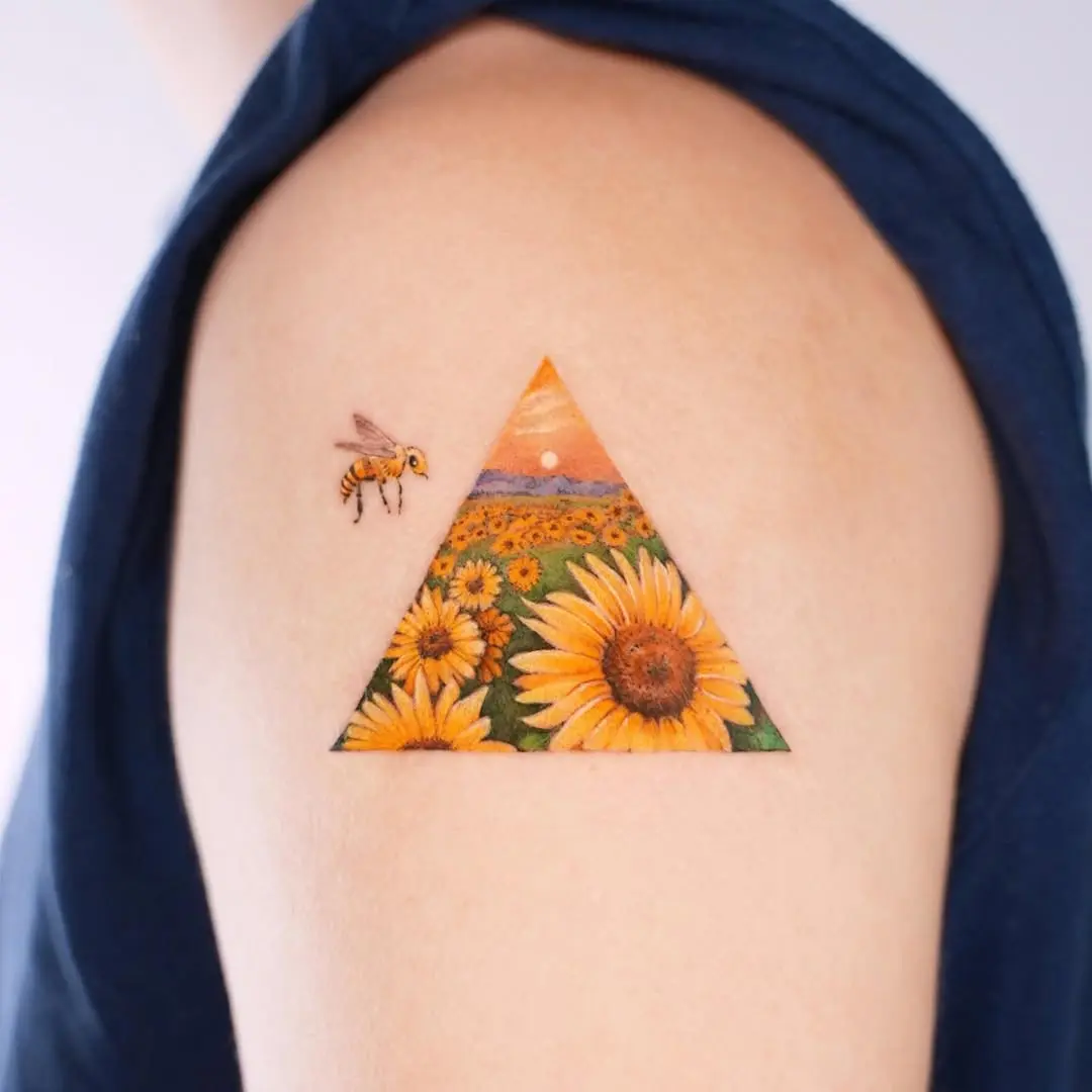 Colorful sunflower tattoo within a triangle canvas.