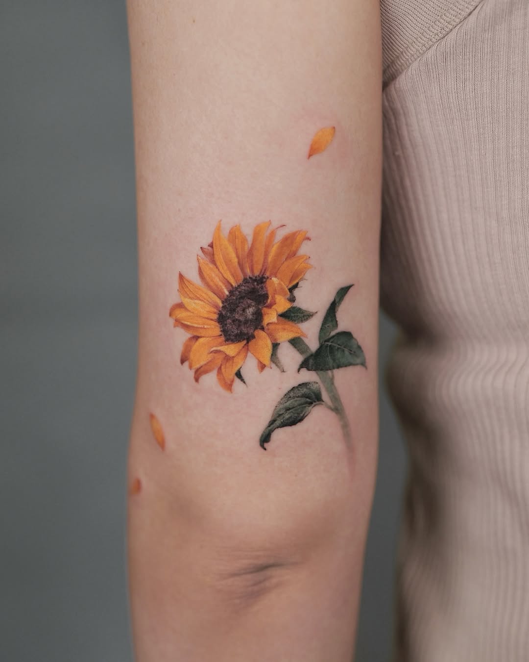 Vivid sunflower tattoo on the arm