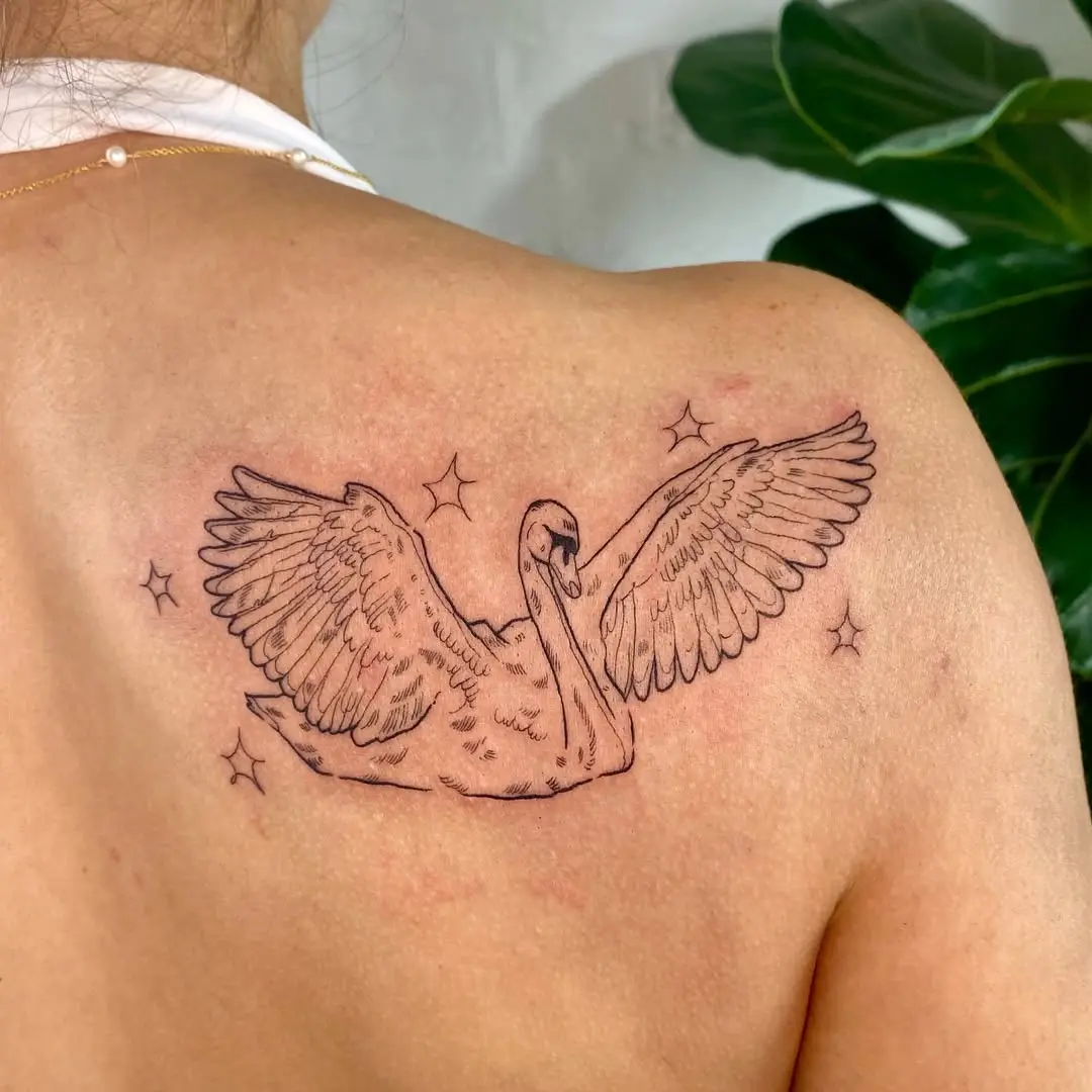 Elegant swan tattoo with graceful wings and stars