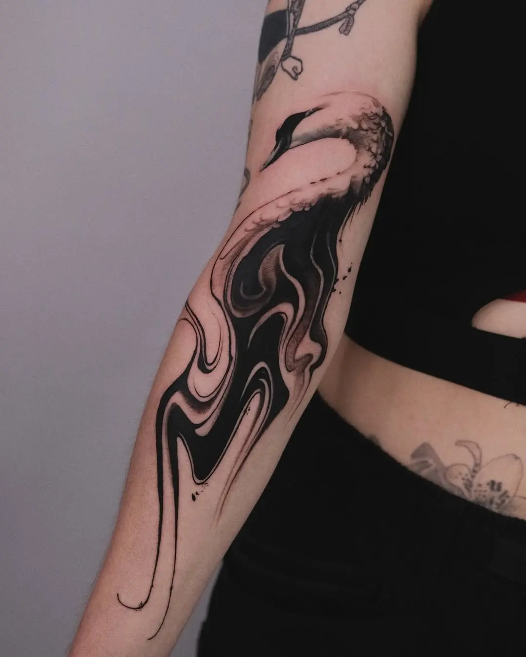 Elegant swan tattoo with abstract design elements