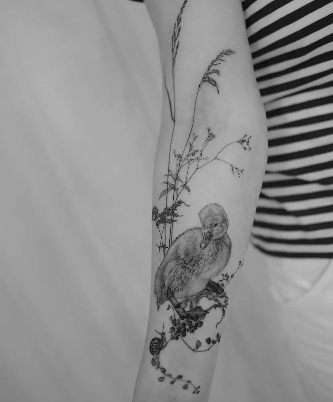 Intricate swan tattoo with nature elements