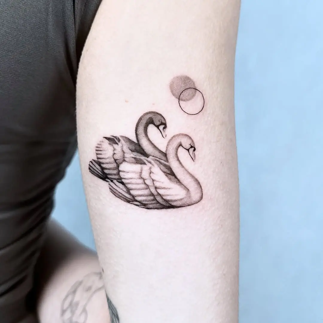 Elegant swan tattoo showcasing love and harmony.