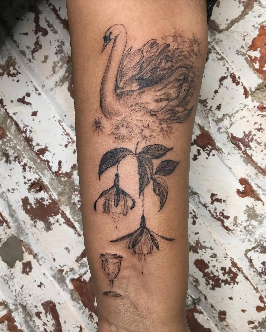 Elegant swan tattoo with floral accents