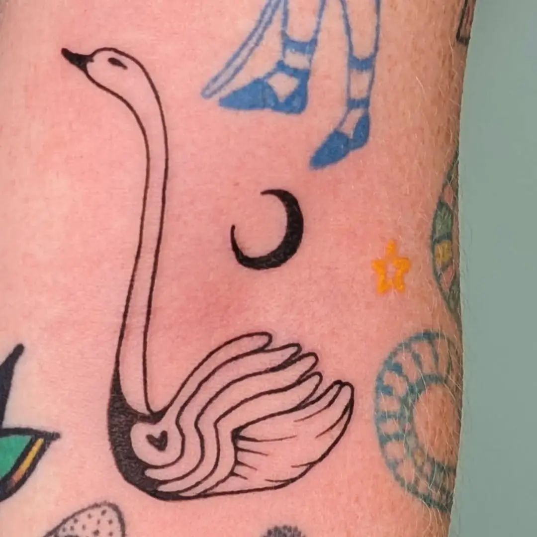 Elegant minimalist swan tattoo on forearm