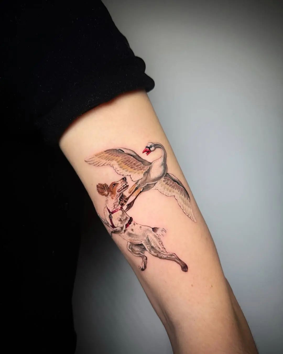 Dynamic Tattoo of Dog Chasing a Swan