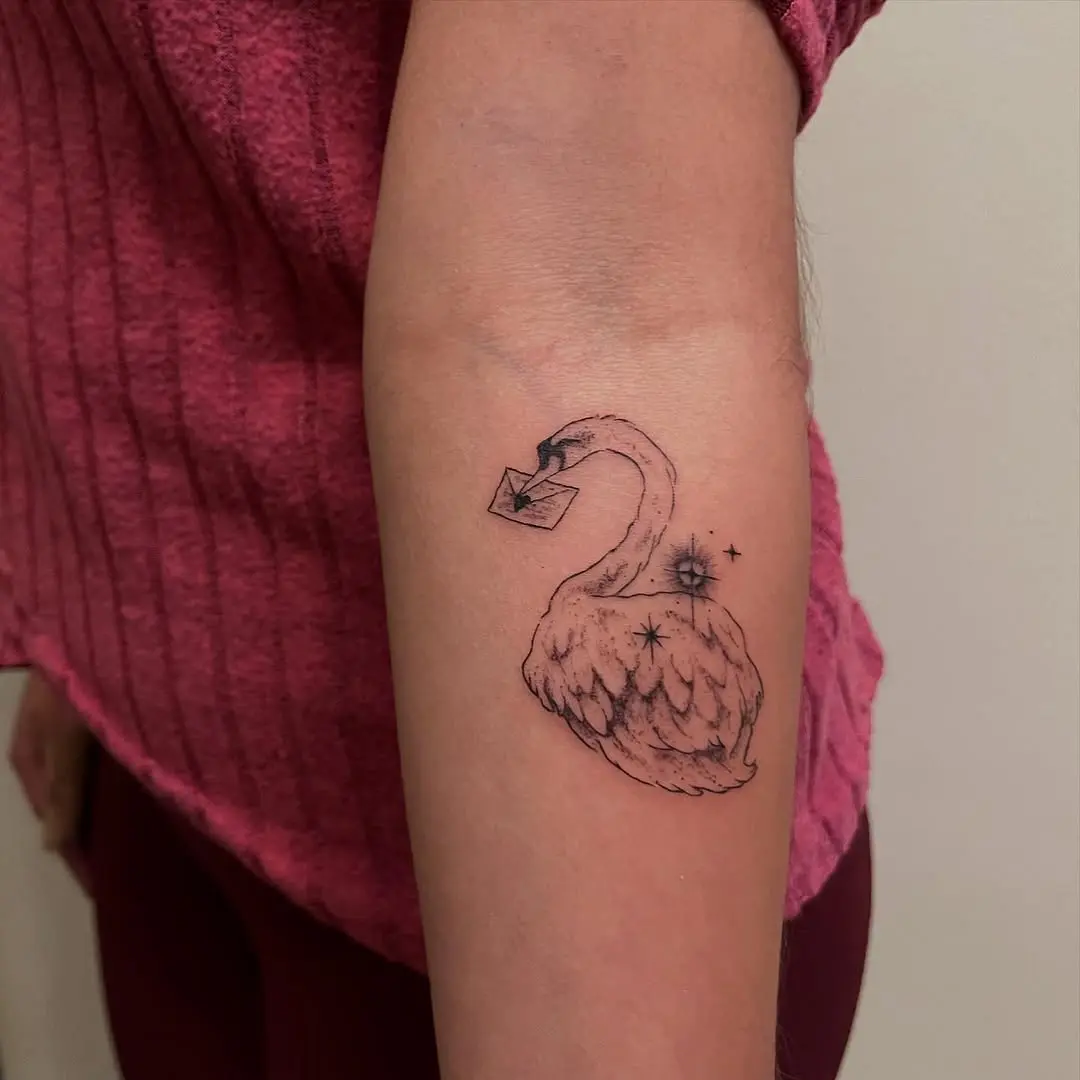 Elegant swan tattoo holding an envelope