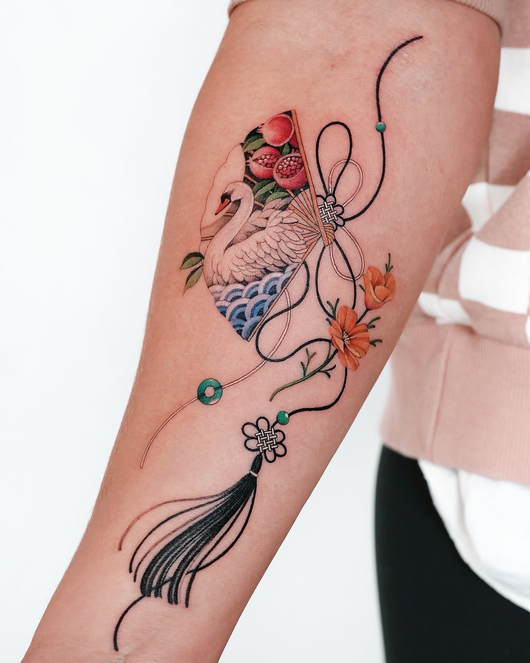 Elegant swan tattoo with floral elements