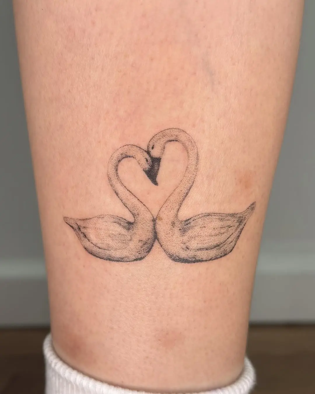Elegant swan tattoo symbolizing love and unity