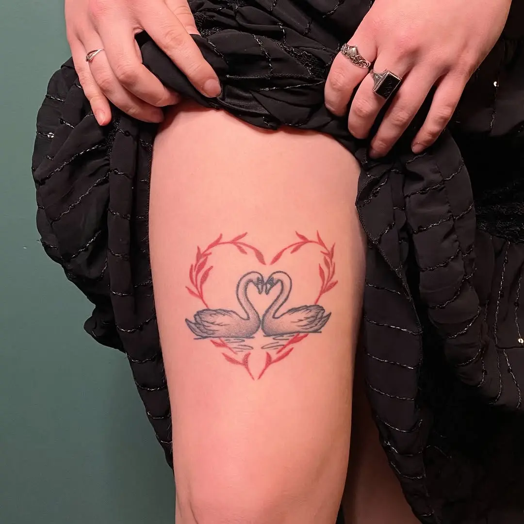 Elegant swans intertwined in a heart shape