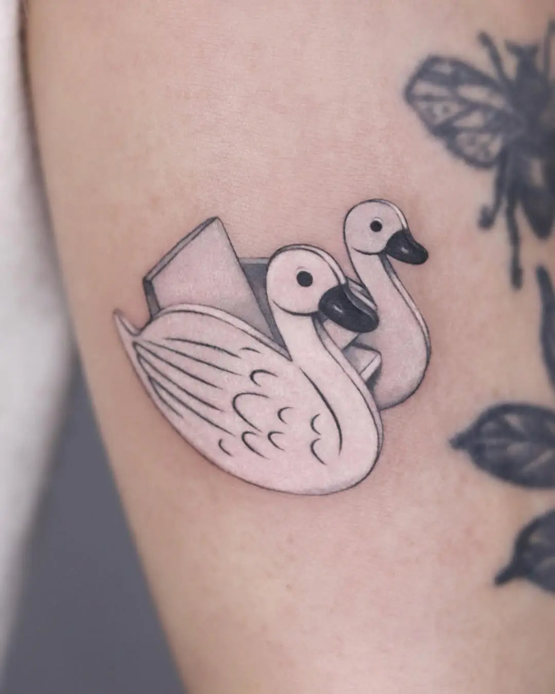 Charming swan tattoo in playful illustration style