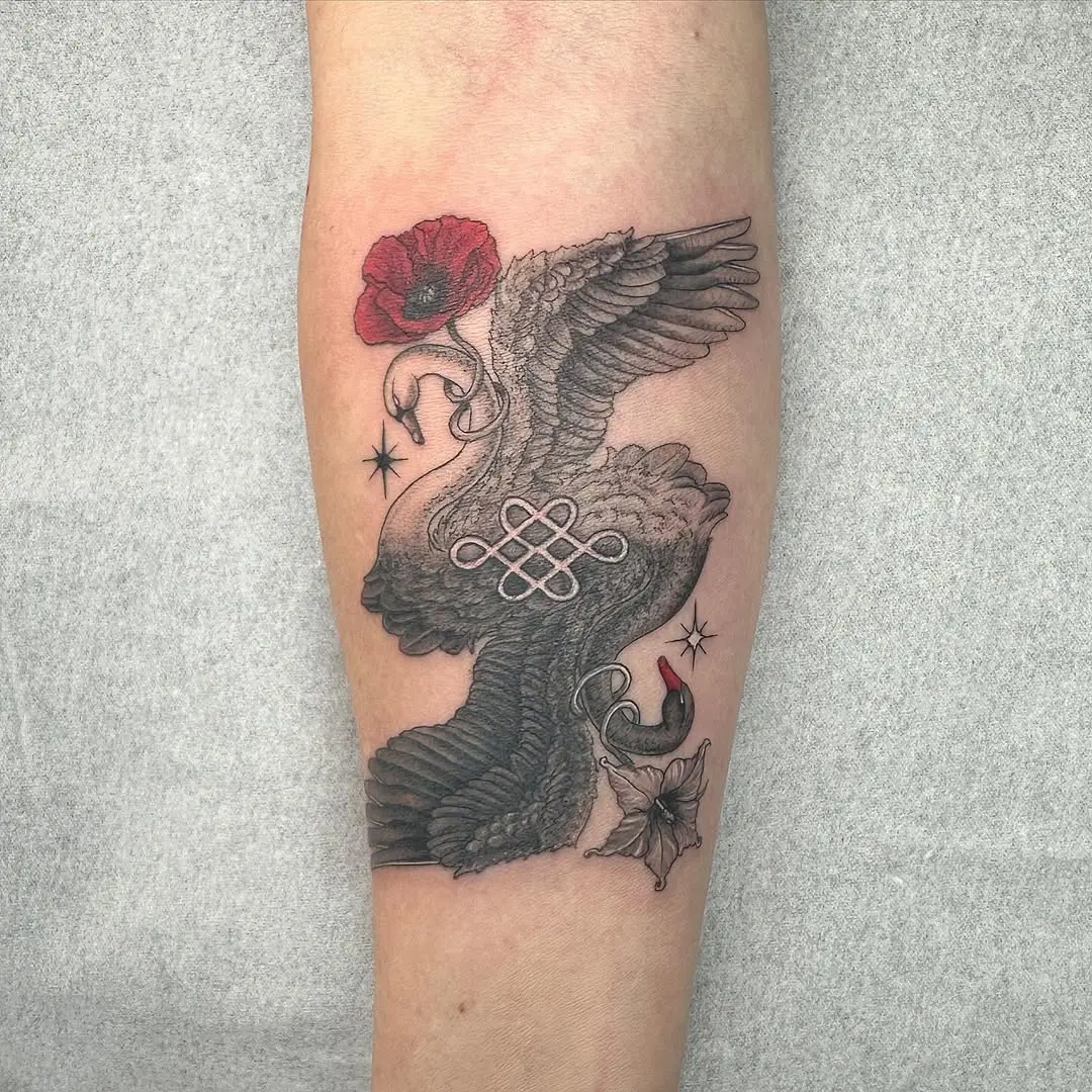 Elegant swan tattoo with poppy flower accent
