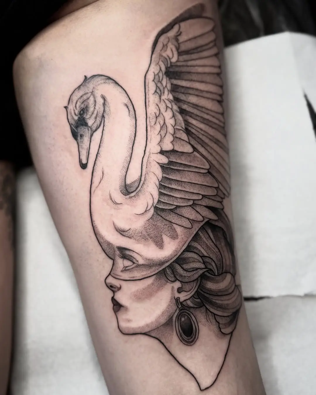 Elegant swan tattoo atop a serene woman's head