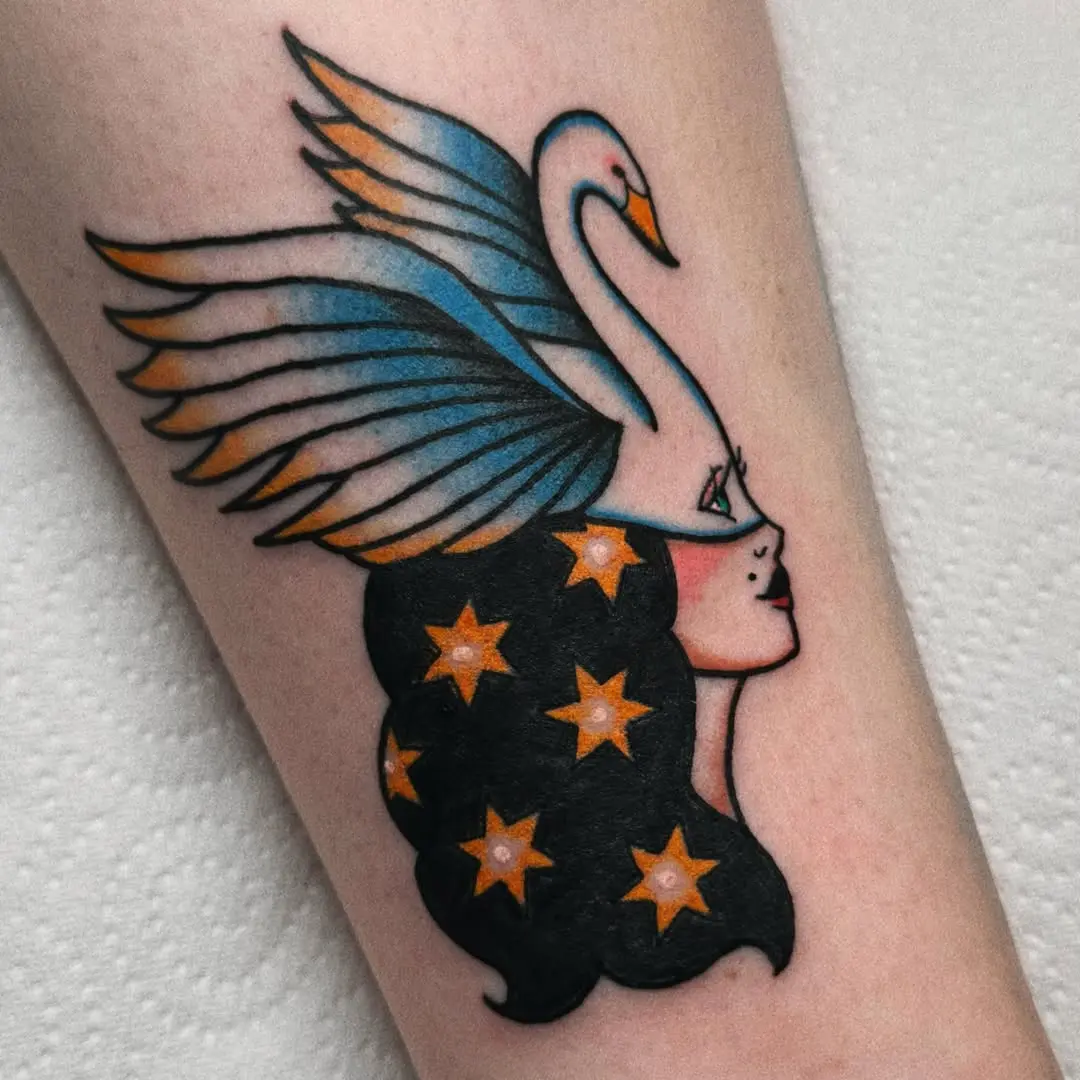 Stylish swan-themed tattoo with a feminine touch