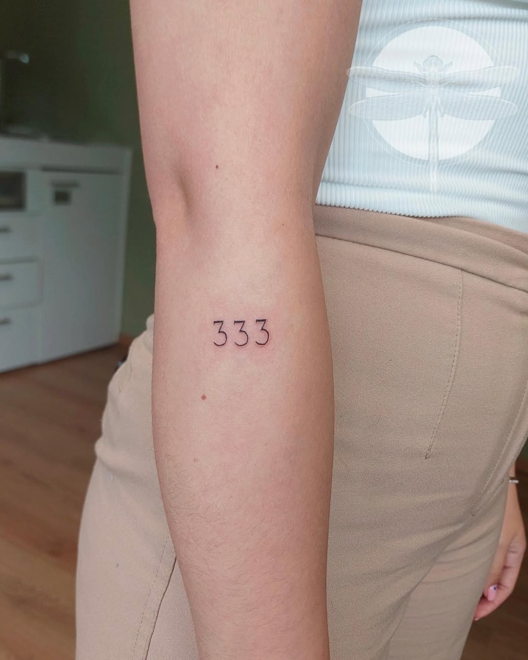 Simple yet striking ‘333’ angel number tattoo