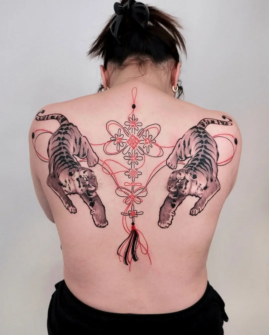 Bold tiger tattoos with floral accents