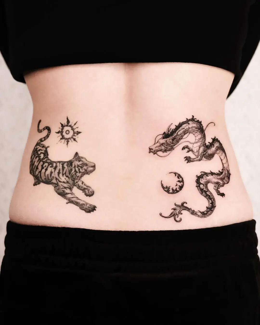 Dynamic tiger and dragon tattoo duo on abdomen